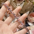 Macro detail of silver plated bracelet with oval pink gemstone and floral zircon accents - Pink Zirconia Four-Petal Flower Style (0018)