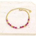 Detailed macro shot of gold-plated bracelet with freshwater pearl and pink stone beads - Deep Pink Beads Teardrop Pearl Style