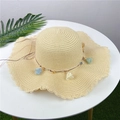 Beige woven straw sun hat for women featuring wavy brim and colorful tassel accents - Adult M / Beige