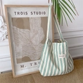 Detail of green and white striped canvas tote bag against artistic home decor - Green Stripes