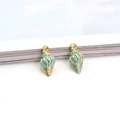 Detail of blue and gold shell charms for DIY jewelry making with enamel finish - Blue Conch