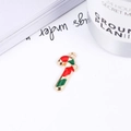 Christmas candy cane pendant in red and green enamel on a minimalist white table setup - No.9 Candy Cane