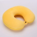 Detail of soft yellow plush U-shaped neck pillow with black snap button fastener - Yellow
