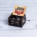 Black wooden Halloween music box featuring a winged eyeball carving and pumpkin art - Hand-cranked Halloween Q