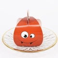 Orange monster-shaped Halloween candy box with large eyes and toothy smile - Orange Monster Style