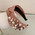 Detail of dusty pink satin headband with hand-sewn pearls and twisted knot design - Pink