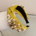 Detailed shot of yellow fabric headband with mixed white and champagne pearls - Yellow