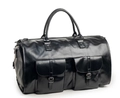 Detail view of the black leather travel bag with large buckled pockets and metal hardware - PU Leather / Leather Black