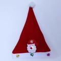 Detail shot of glowing Santa Claus LED decoration on a red plush Christmas hat with snowflakes - Adult Glow Santa