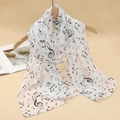Detail of white chiffon scarf with black music note print hanging on a wooden hanger - White Black Music Note