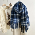 Detail of blue and white striped mohair scarf featuring long tassels and soft texture - Blue