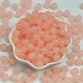 Pink translucent glass jade-like beads in a white bowl for DIY jewelry making - 4mm / Peach