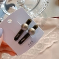 Detail view of two dark brown hair clips with gold beads and France engraving on card - Pearl Style Gray Pair