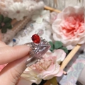 Detail of red pear-shaped ruby ring with 18K gold crown setting and clear crystal stones - Adjustable Open / Silver Ruby Red Zirconia