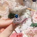 Macro shot of silver crown ring featuring a teardrop blue gemstone and micro diamonds - Adjustable Open / Silver Royal Blue Zirconia