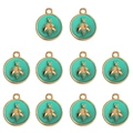 Detailed view of ten turquoise enamel round bee pendants with gold-plated alloy frames - Green
