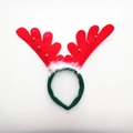Detail of red reindeer antlers headband with white plush trim and gold bells on white background - Red Feather Antlers with Small Bells