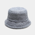 Close-up of soft light blue teddy fleece material on a winter bucket hat for women - M / Fog Blue