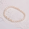 Elegant natural freshwater pearl bracelet with gold beads on a white lace background - Adjustable Open / White