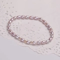 Elegant natural lavender freshwater pearl bracelet with golden beads on lace background - Adjustable Open / Pink Purple