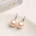 Macro view of light pink freshwater pearl earrings with silver metal hooks on a white bowl - Gold Plated Copper / Standard / Silver Pink Purple Pearl
