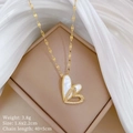 Close-up of double heart pendant with white shell and diamonds on a gold necklace - Double Heart Mother of Pearl Zirconia Style (A535)