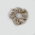 Detailed view of champagne gold satin scrunchie with elegant pleated fabric texture - Satin 17 (Champagne Gold)