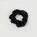 Macro shot of black satin scrunchie showing smooth texture and elastic pleats detail - Satin 38 (Black)