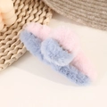 Detailed close-up of a pink and blue plush shark hair claw clip on a woven background - Tiffany Blue