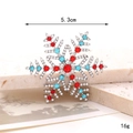 Detail of snowflake brooch with red and blue rhinestones on stone background - D2719 Colorful Snowflake