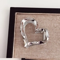 Detail view of a silver heart-shaped metal hair claw clip with high-shine plating - Heart / Silver
