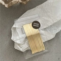 Dettaglio dei fermagli per capelli in metallo oro opaco in busta con etichetta - Oro