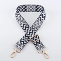 Close-up of geometric jacquard shoulder strap with golden metal lobster clasps and buckle - Light Gold Buckle / Dark Blue