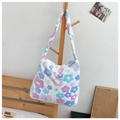 Cute plush shoulder bag with blue and pink floral patterns on a soft white background - White