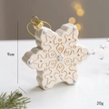 Creamy white snowflake Christmas ornament with golden accents and textured resin detail - Snowflake
