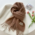 Close-up of brown cashmere scarf with fringe on white coat and pink tulips - Mocha