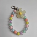 Detail of colorful transparent candy beads and yellow resin flower charm with metal clasp - Multicolor Beads Yellow Flower
