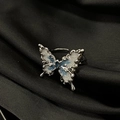 Detail of silver butterfly ring with blue enamel on black silk background - Adjustable Open / Silver Blue and White Enamel Butterfly (JZ4418)