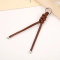 Detail of hand-woven brown PU leather cord keychain with polished silver metal clasp - Brown