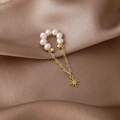 Detail of freshwater pearl ear cuff with golden tassel and sparkling star pendant - Star Style