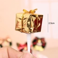 Macro view of 2.5cm golden miniature gift box cake topper with gold ribbon and stick - Gold Gift Box