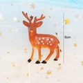 Detail view of 6cm tall spotted fawn cake topper figurine on star patterned tulle - Sika Deer