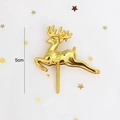 Detail of 5cm golden reindeer cake topper with metallic finish on white background - Golden Reindeer