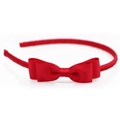 Detailed close-up of a vibrant red grosgrain ribbon bow headband on white background - Red
