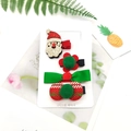 Detail of Christmas hair clip set featuring Santa, velvet bow and pom-poms on display card - 4-Piece Santa Claus Set