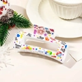White New Year hair claw clip with Happy New Year print and festive patterns - White