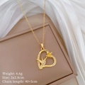 Close-up of golden hummingbird and flower heart pendant on beige jewelry box display - Gold Heart Hummingbird Flower Style (A225)