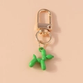 Detail of a bright green balloon dog keychain with a polished gold metal clasp and ring - Green