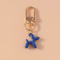 Detail of creative blue balloon dog keychain with golden horseshoe clasp on pink background - Dark Blue