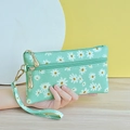 Mint green double zipper clutch bag featuring white daisy prints and a wrist strap - Pale Green